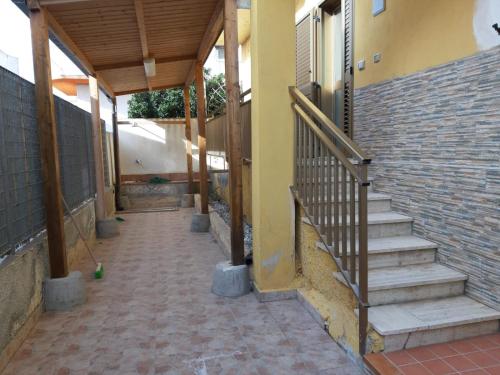 a hallway of a building with stairs and a brick wall at DUE PASSI dal MARE in Cittadella del Capo