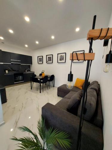 a living room with a couch and a table at The Stone Loft Cuccureddu in Lotzorai