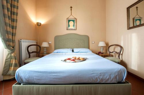 Säng eller sängar i ett rum på Residence Villa Savoia