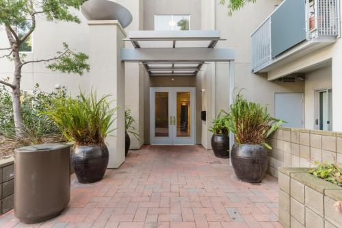 a hallway of a building with potted plants at Blueground Santa Clara 2bd apartment SFO-1771 in Milpitas