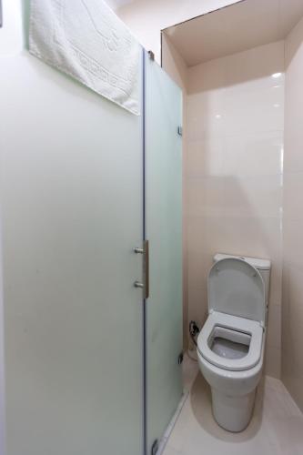 a small bathroom with a toilet and a door at Hillside Boutique Hotel Baku in Baku