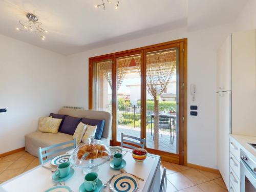 a living room with a couch and a table at Adeline Garda Nest by Bookinggardalake in Raffa