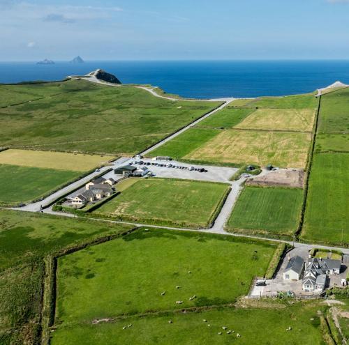 an aerial view of a farm with the ocean in the background at Skellig View Kerry Cliffs View Balcony Room in Portmagee