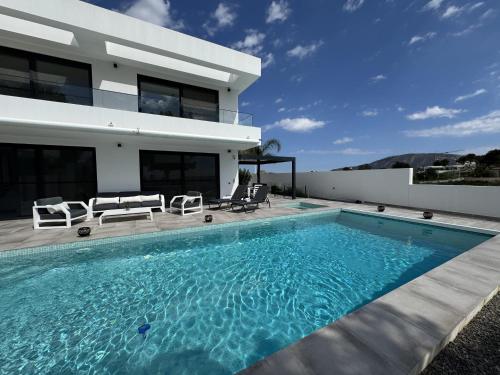 a swimming pool in front of a house at Luxury Villa Felicita Moraira in Moraira