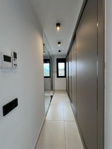 a hallway with white walls and silver doors at Luxury Villa Felicita Moraira in Moraira