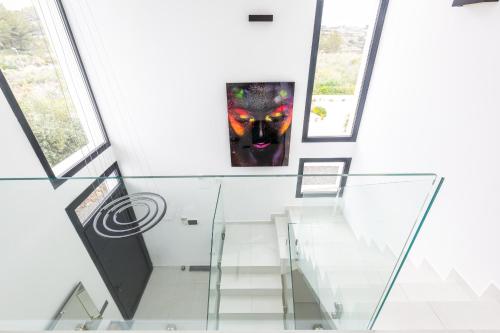 a painting on the wall in a room with windows at Luxury Villa Felicita Moraira in Moraira