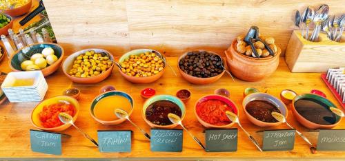 a wooden table with bowls of different types of food at My Cave Suites in Nevsehir