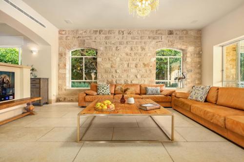 a living room with a couch and a table at The Stone Age Palace with Mamad by Sea N Rent in Caesarea