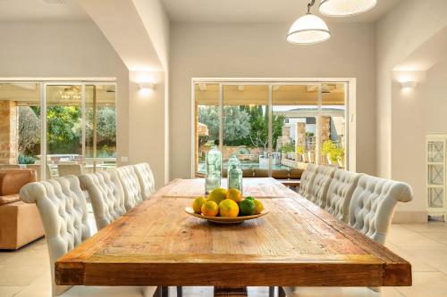 a dining room table with a bowl of fruit on it at The Stone Age Palace with Mamad by Sea N Rent in Caesarea