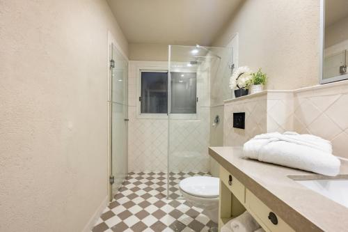 a bathroom with a toilet and a glass shower at The Stone Age Palace with Mamad by Sea N Rent in Caesarea