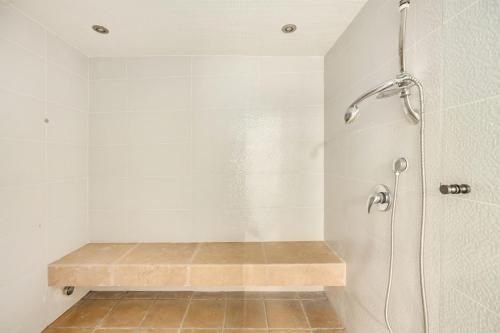 a shower stall with a bench in a bathroom at The Stone Age Palace with Mamad by Sea N Rent in Caesarea