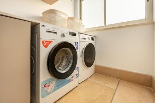 a washer and dryer in a laundry room at The Stone Age Palace with Mamad by Sea N Rent in Caesarea