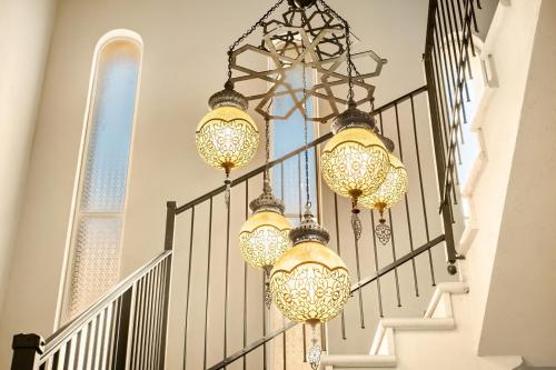 a chandelier hanging from a staircase in a house at The Stone Age Palace with Mamad by Sea N Rent in Caesarea