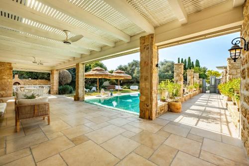 an outdoor patio with a swimming pool and a house at The Stone Age Palace with Mamad by Sea N Rent in Caesarea