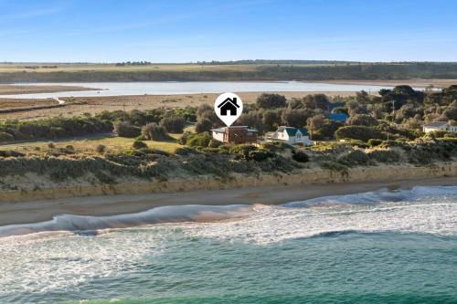 an aerial view of a beach with a sign at Honeysuckles Ultimate Beach Escape in Seaspray