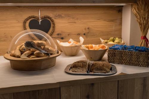 a counter top with a bunch of food on it at Biker Hotel Al Gallo Forcello in Passo Pramollo