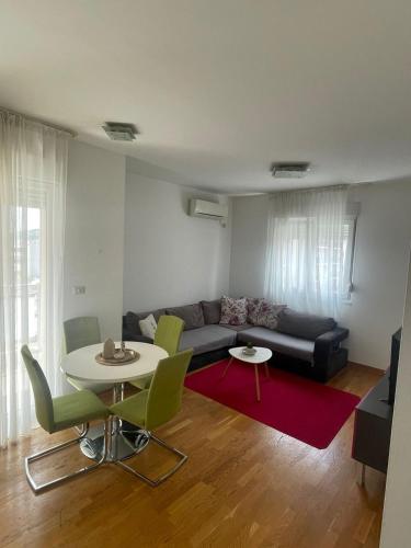 a living room with a couch and a table at District Loft in Podgorica