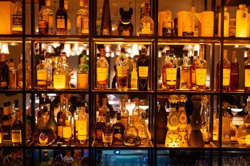 a room filled with lots of bottles of alcohol at Lear Sense Hotel in Gedera