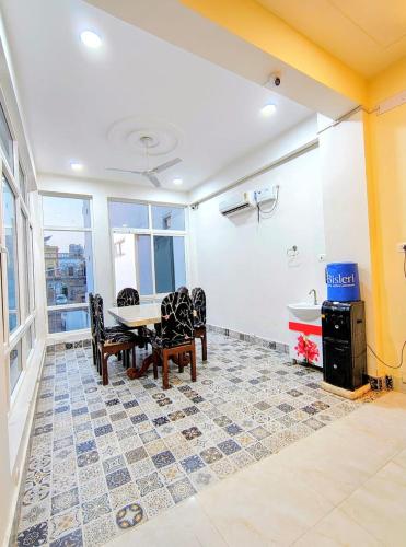 a dining room with a table and chairs at Hotel in New Delhi