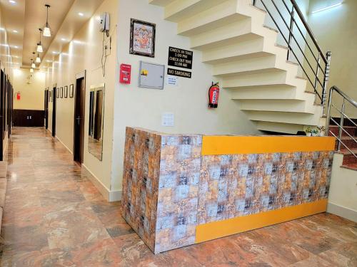a hallway with a staircase and a tile wall at Hotel in New Delhi