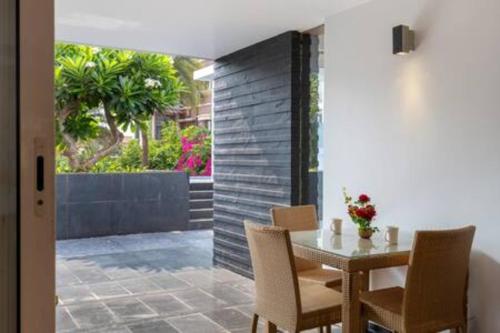 a dining room with a table and chairs at St Jacinto Island Villa10 2Pools Bay View in Dabolim