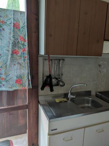 a kitchen with a sink and a counter top at Casa Sole - Pernottamento accogliente a Castione Marchesi in Castione dei Marchesi