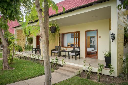 a patio of a house with chairs and a table at Sala Siem Reap Resort in Siem Reap