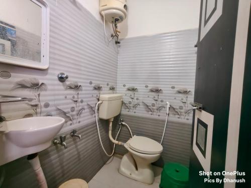 a bathroom with a toilet and a sink at Annamaiah Guest House & Homestay - Tirupati - Home Food Service in Tirupati