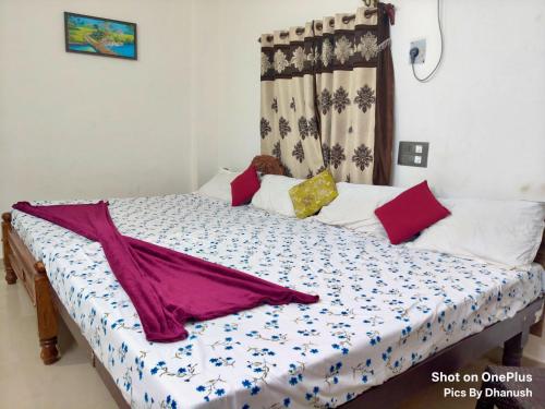 a bed in a room with a curtain at Annamaiah Guest House & Homestay - Tirupati - Home Food Service in Tirupati