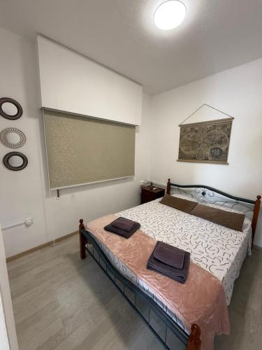 a bedroom with a bed with two towels on it at Makenzy Mermaid 2 Bedroom Apartment in Larnaca