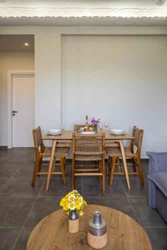 a dining room with a table and chairs at Elia Syros in Vari