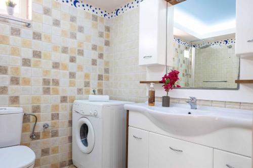 a bathroom with a washing machine and a sink at Dreamview Villa in Agios Nikolaos
