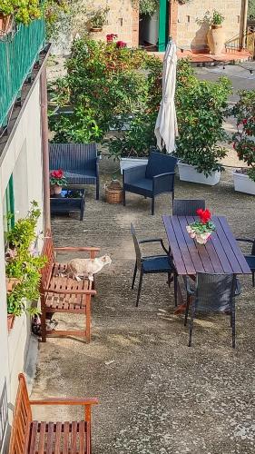 a patio with a table and chairs and a cat sleeping at Casa Vacanze Nino Petrelli in Naso