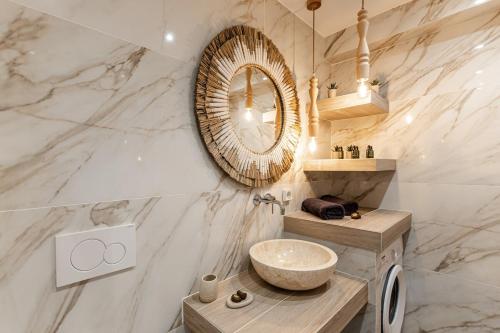 a bathroom with a sink and a mirror at Ruby of Naxos Residences in Kastraki