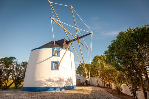 a windmill sitting on the side of a building at The Indigo Windmill Retreat, Peniche in Atouguia da Baleia