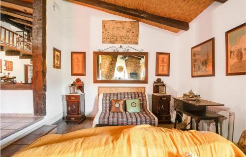 a bedroom with a bed and a desk and a mirror at Comfortable villa with mountain views - Valverde de Leganés in Valverde de Leganés