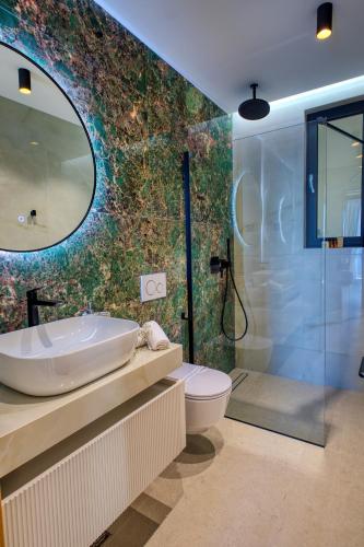 a bathroom with a tub and a toilet and a shower at La Dolce Villa in Dubrovnik