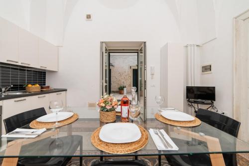 a dining room with a glass table with two chairs at CASA PAPADIA in Uggiano la Chiesa