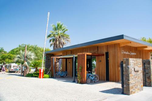 a building with bikes parked outside of it at Camping Au Paradis des Campeurs Premium in Roquebrune-sur-Argens