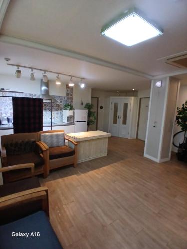 a living room with a couch and a table at Pohang Youngildae Guesthouse in Pohang