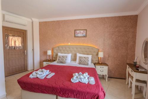 a hotel room with a bed with towels on it at Knights' Castle Studios in Archangelos
