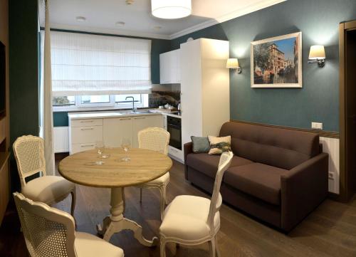 a living room with a couch and a table at ZENTRUM Hotel in Chişinău