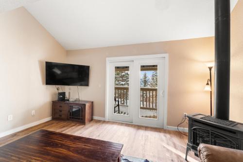 a living room with a flat screen tv and a fireplace at Rockridge 51 by Summit County Mountain Retreats in Breckenridge