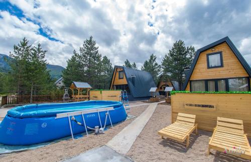 a backyard with a pool and a house at Natural Dream Blidinje in Rudo Polje