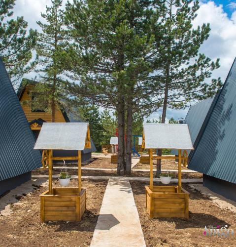 a playground with two gazebos and a tree at Natural Dream Blidinje in Rudo Polje