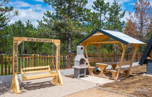 a playground with a bench and a gazebo at Natural Dream Blidinje in Rudo Polje