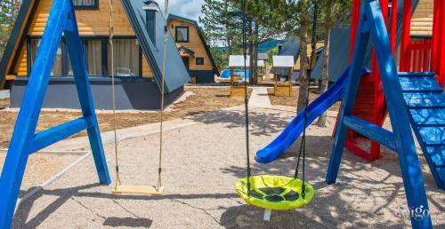 a playground with two swings and a slide at Natural Dream Blidinje in Rudo Polje
