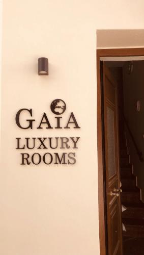 a sign on the side of a building at Gaia Luxury Rooms Rethymno in Rethymno Town