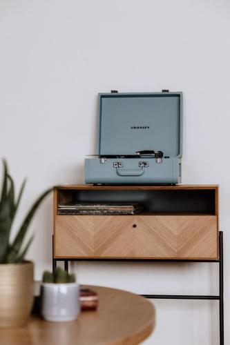a tv sitting on top of a wooden entertainment center at G'sund & Natur Hotel Die Wasnerin - Adults Only in Bad Aussee