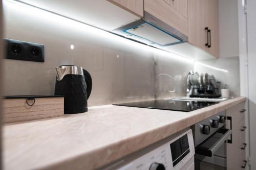 a kitchen with a sink and a counter top at Domaris Luxury Suite in Mitikas